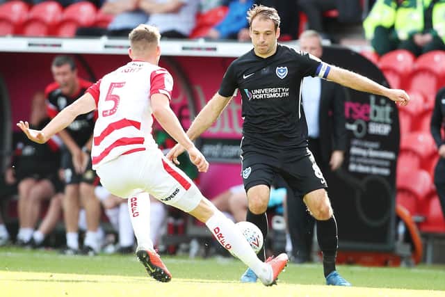 Brett Pitman takes on Joe Wright after appearing as a substitute at Doncaster. Picture: Joe Pepler.