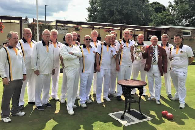 Leigh Park captain Peter Robinson receives the Rowland Cup from Portsmouth & District Bowls Association president Ken Graham