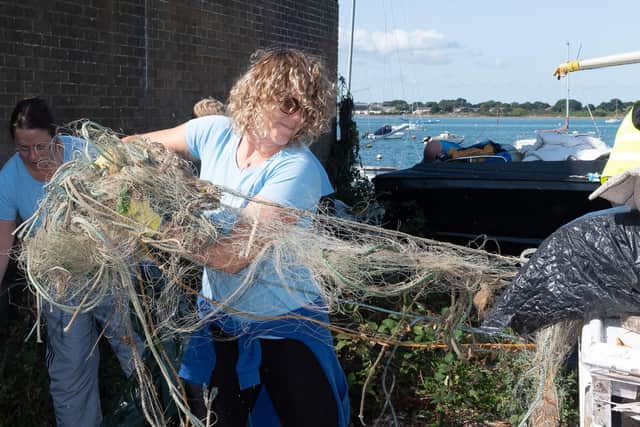 Shanelle Kohler drags a fishing net and other debris from the fly-tipped rubbish.
Picture: Keith Woodland