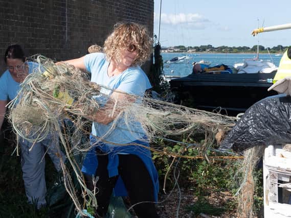 Shanelle Kohler drags a fishing net and other debris from the fly-tipped rubbish.
Picture: Keith Woodland