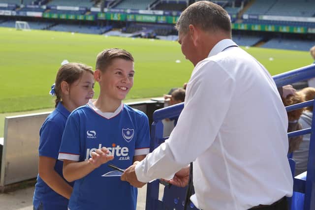 Pompey fan Billy Hougham receives an autograph off chief executive Mark Catlin. Picture: Habib Rahman