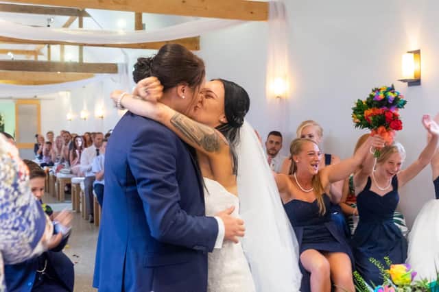 Sarah Brazier and Joelene Brazier kiss at their wedding. Picture: Carla Mortimer Photography