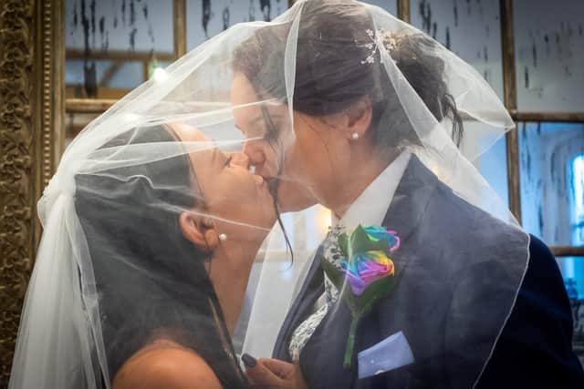 Sarah Brazier and Joelene Brazier kiss at their wedding. Picture: Carla Mortimer Photography