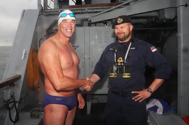 Lt Cdr Mark Heward, the commanding officer of Portsmouth-based minehunter HMS Hurworth welcomes Lewis Pugh on board before he completed his Channel swim.