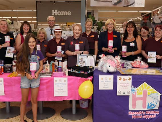 Sainsburys colleagues including operations manager Lizzie Spacey, fourth right, welcome Pam Marshall, third right, and her daughter, Grace, 11, front. Hannahs Holiday Home Appeal has been chosen as Charity Of The Year at Sainsburys Farlington    Picture: Chris Moorhouse