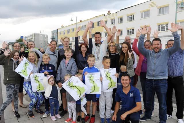Ross's friends and family welcome him to the finish line. Picture: Malcolm Wells
