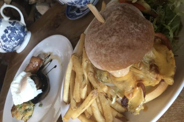 Steak burger on a toasted sourdough bun with home seasoned fries, lettuce, special recipe sauce, bacon and cheese, and the chargrilled pork steak with pan-fried bubble and squeak, fried egg, grilled tomato and mushroom.