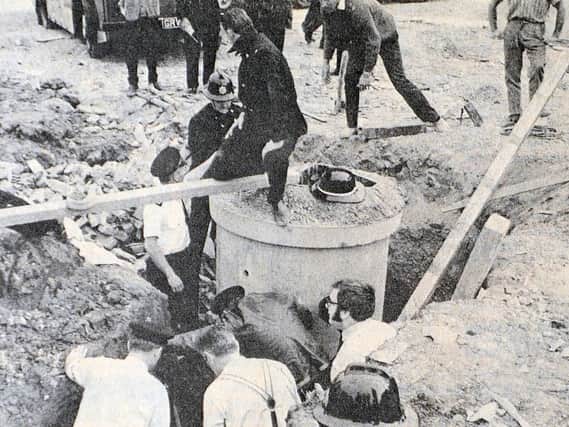 Men at work to rescue the man buried alive at Mile End.