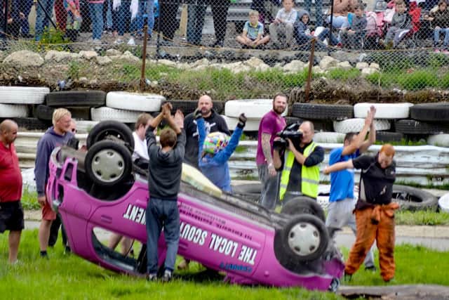 Sophie throws her hands in the air after clambering out of her wrecked motor. Picture: www.shuttersphotography.co.uk / Makaela Papworth