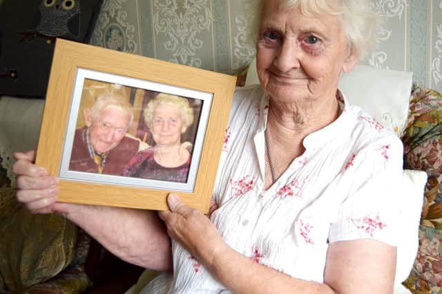 Rita Muston, 82, of Merchistoun Road, Horndean, holding a picture of her and her late husband, Brian, 86 Picture: Tom Cotterill