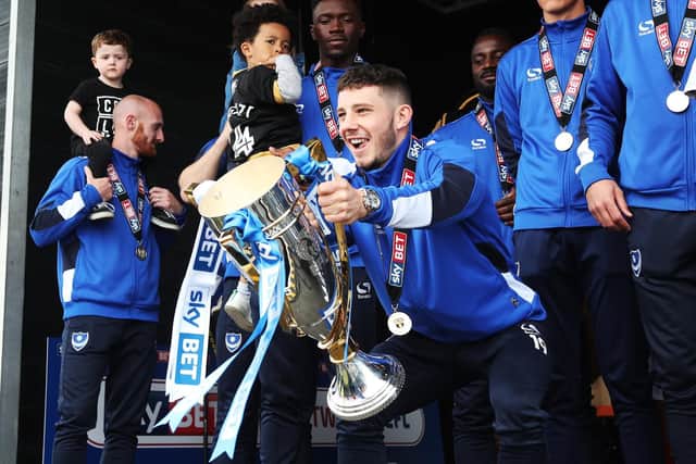 Conor Chaplin lifts the League Two title. Picture: Joe Pepler