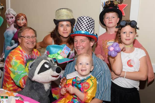 Alex and Meko entertains Poppy Robertson surrounded by her family. Picture: Keith Woodland