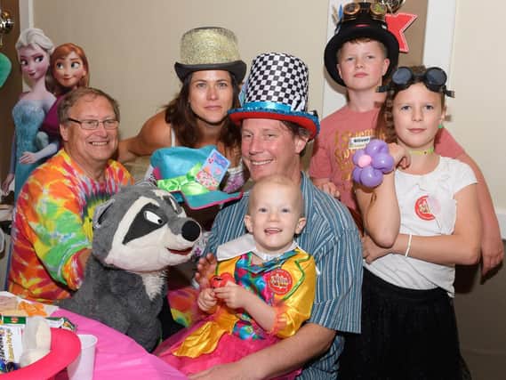 Alex and Meko entertains Poppy Robertson surrounded by her family. Picture: Keith Woodland