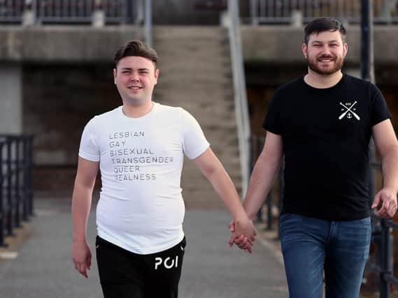 Business partners and couple Tom Pearson, right, and Tony Read at the launch of their Pride T-shirts, part of their PO1Realness brand, Hotwalls, Old Portsmouth. Picture: Chris Moorhouse