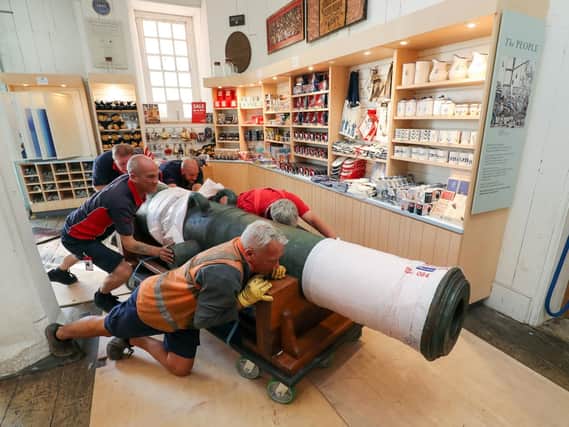 Workmen move a 42-pound cannon into position, which is the first artefact from the legendary HMS Victory 1744 wreck site to be shown to the public at The National Museum of the Royal Navy in Portsmouth Historic Dockyard. Picture: Andrew Matthews