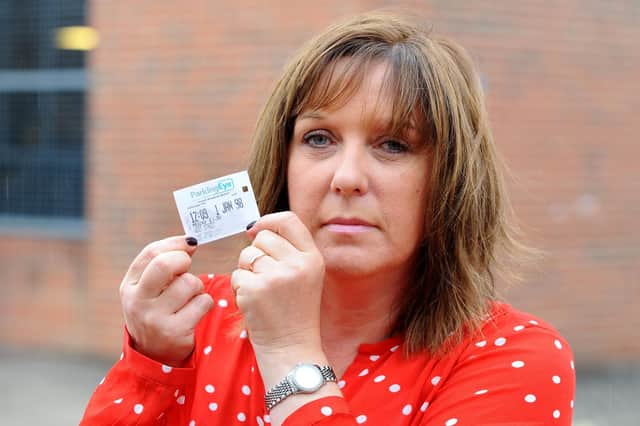 Julie Escott, with the parking ticket bizarrely dated January 1, 1998. Picture: Sarah Standing