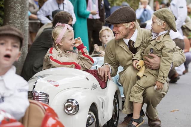 Lila Clements, 8, with brother Lenny, 3 and dad Andrew from Portsmouth pictured preparing for the Settrington Cup, a pedal car race for Austin J40 pedal cars at The Goodwood Revial. Picture: Oliver Dixon