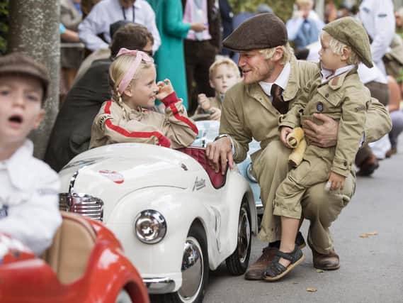 Lila Clements, 8, with brother Lenny, 3 and dad Andrew from Portsmouth pictured preparing for the Settrington Cup, a pedal car race for Austin J40 pedal cars at  The Goodwood Revial. Picture: Oliver Dixon