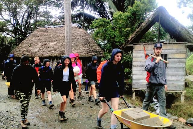 Mayville school pupils in the Andes where pupils took part in a building project building roads and plastering homes. Here they are helping to create a medicine garden and water storage facility