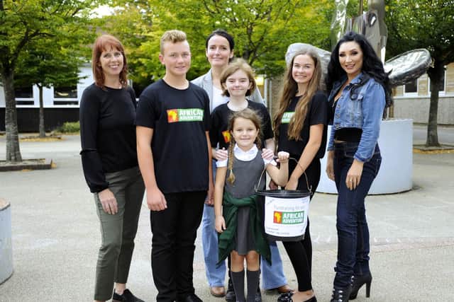 Ellie-May Sheridan, centre, with her family and school friends - from left: teacher Emma Forrest, Alfie Heard (14), Ellie-May's mum Katherine Reed, Ellie-May's sister Rosie Reed,  Emilia Barnden and singer Rachael Hawnt    Picture:  Malcolm Wells (180911-2509)