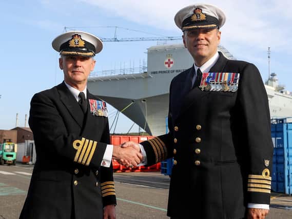 HMS Prince of Wales's new commanding officer, Captain Stephen Moorhouse, right, with the ship's former senior naval officer, Captain Ian Groom, left.
Photo: Royal Navy