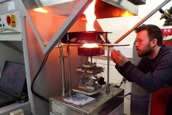 Laurence Casey applying water to an aluminium panel