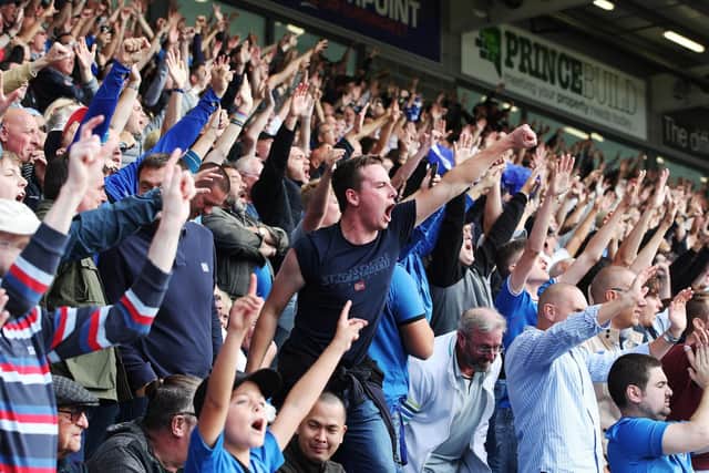 The Pompey fans celebrate at London Road today