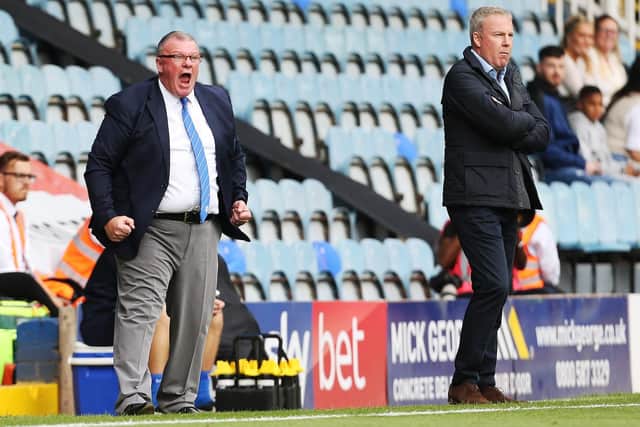 Peterborough boss Steve Evans, left, and Pompey manager Kenny Jackett on the touchline