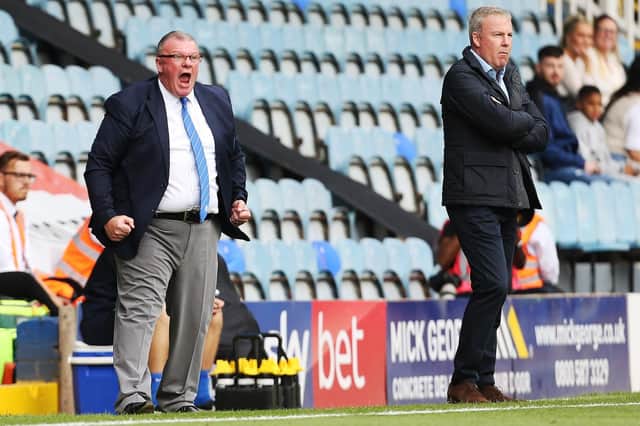 Peterborough boss Steve Evans, left, and Pompey manager Kenny Jackett on the touchline