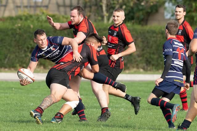 Fareham Heathens player Rikky Curtis tackles a Sandown & Shanklin opponent. Picture: Keith Woodland