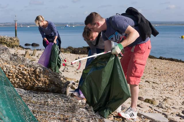 People getting stuck into the Great Solent Beach Clean close to the RNLI Portsmouth Lifeboat Station, at Ferry Road, Eastney. Picture: Duncan Shepherd