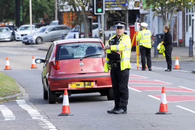 Police officers in Rowner Road, Gosport, at the junction with Gorselands Way, on Wednesday afternoon after a pensioner was hit by a car. Picture: Malcolm Wells.