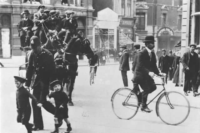 PC George Poore seeing another two children across Commercial Road