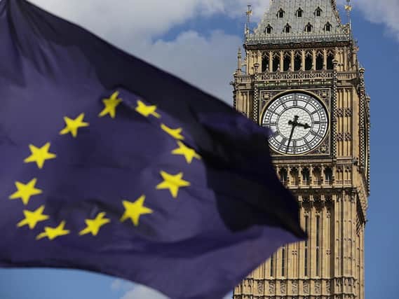 An EU flag flies in the face of Parliament