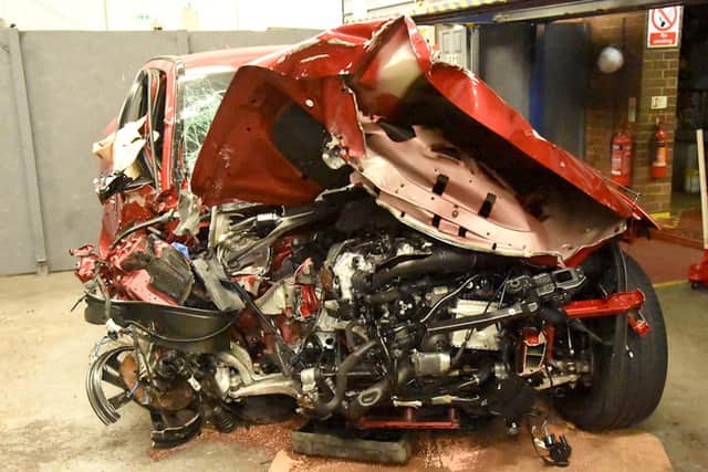 Kevin Zhou's red Jaguar F Type 4x4 after the crash on the A259. Picture: Sussex police