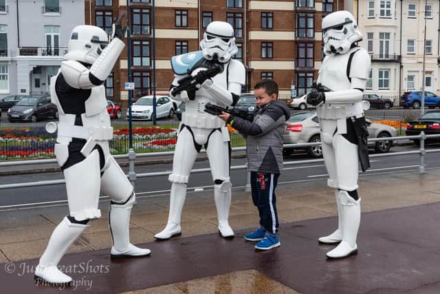 One youngster points a blaster at a Stormtrooper. Photo: Richard Welch - JustGreatShots
