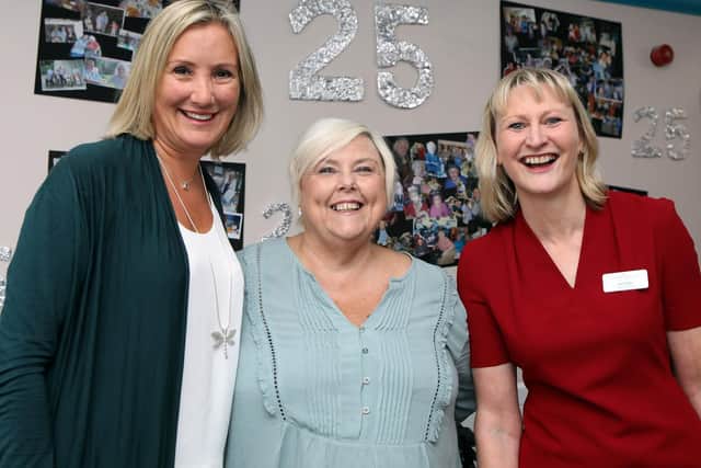 Caroline Dinenage (left) alongside the staff of Russell Churcher Court
