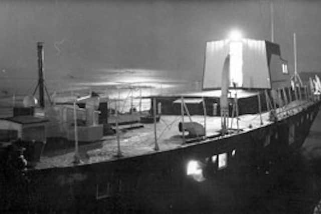 Percy and Vi Wearns tied up alongside the Eastern Road forshore. A very romantic scene with the moon rising over Langstone Harbour.