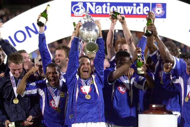 Paul Merson lifts the Division One title for Pompey. Picture: Steve Reid