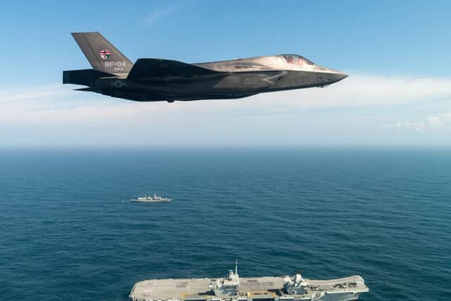 The first F-35 flies past HMS Queen Elizabeth ahead of landing on the Royal Navy's future flagship. Photo: Lockheed Martin