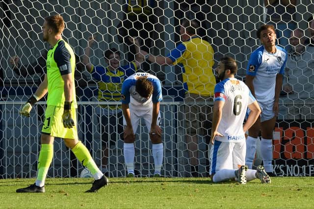The Hawks are dejected after Solihull Moors net a stoppage-time winner. Picture: Keith Woodland