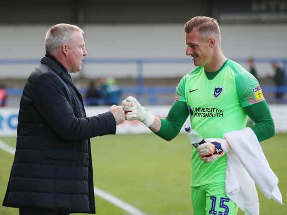 Pompey boss Kenny Jackett, left, toasts his side's win at Rochdale with keeper Craig MacGillivray. Picture: Joe Pepler