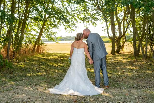 Tina and Kev share a kiss under the sun on their wedding day. Picture: Carla Mortimer Photography