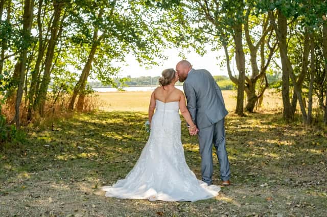 Tina and Kev share a kiss under the sun on their wedding day.   Picture: Carla Mortimer Photography