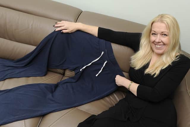 Kerrie Bailey with a pair of trousers she wore before her dramatic weight loss