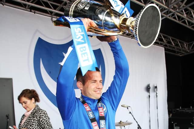 Michael Doyle holds aloft the League Two trophy when Pompey skipper