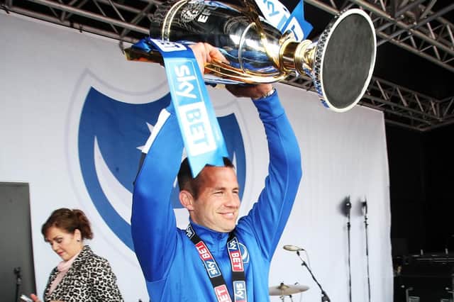 Michael Doyle holds aloft the League Two trophy when Pompey skipper