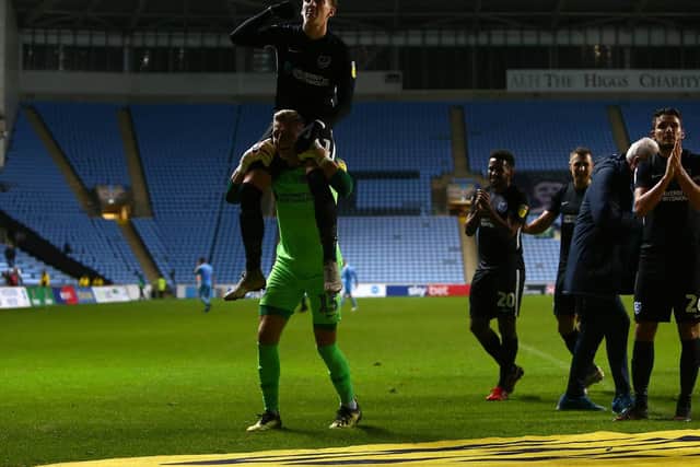 Craig MacGillivray hoists Ronan Curtis on his shoulders to celebrate Pompey's win at Oldham. Pictures: Phillip Oldham