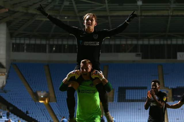 Ronan Curtis toasts Pompey's win at Coventry on the shoulders of Craig MacGillivray. Picture: Philip Oldham