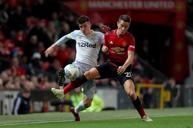 Derby County's Mason Mount and Manchester United's Ander Herrera challenge for the ball.